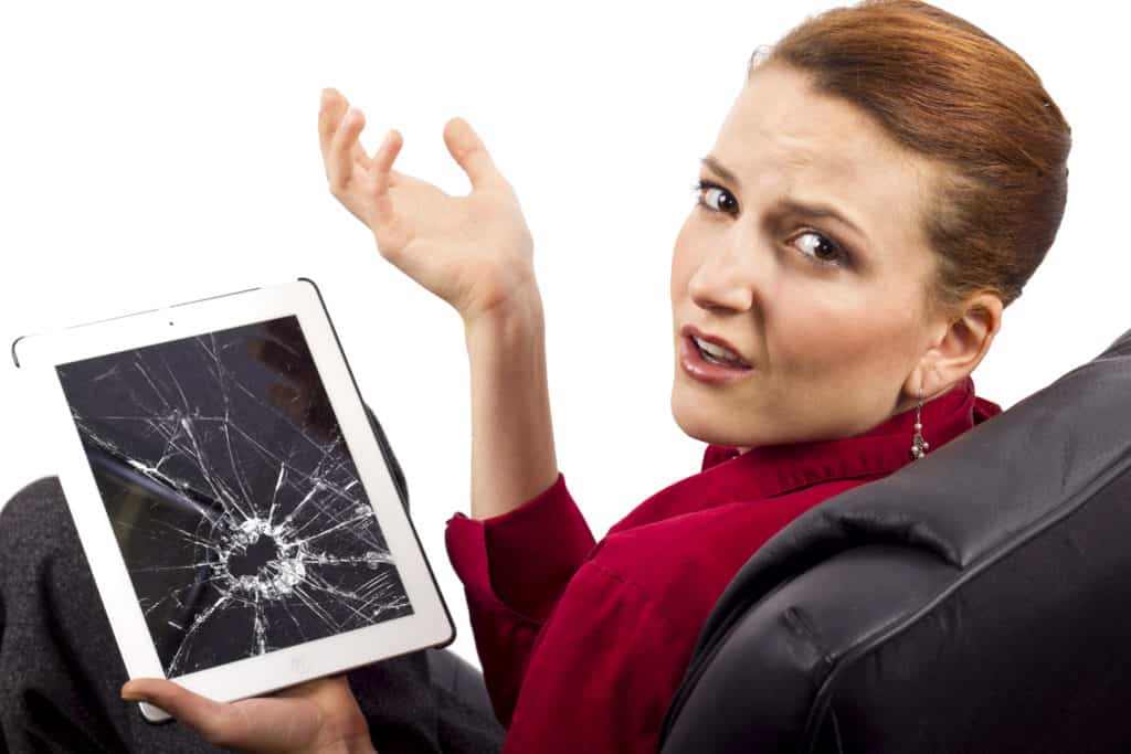 A cracked and broken iPad screen with the digitizer glass shattered, housing intact