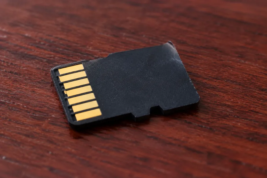 MicroSD card resting on a wood desk, a reminder to back up video footage regularly