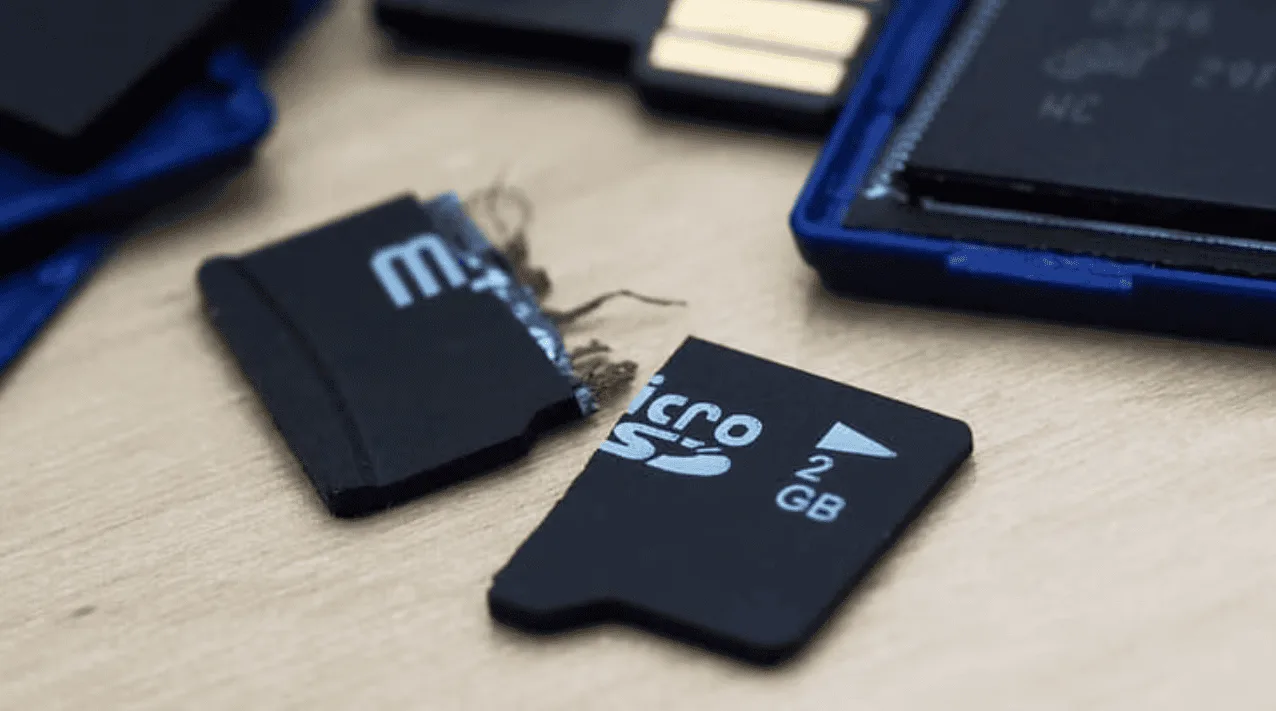 A physically broken SD card snapped through the housing — eProvided recovers the data via chip-off NAND extraction